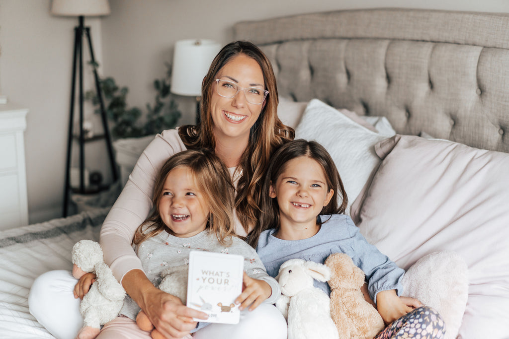Mother with two small children holding an affirmation card that says "what's your power"